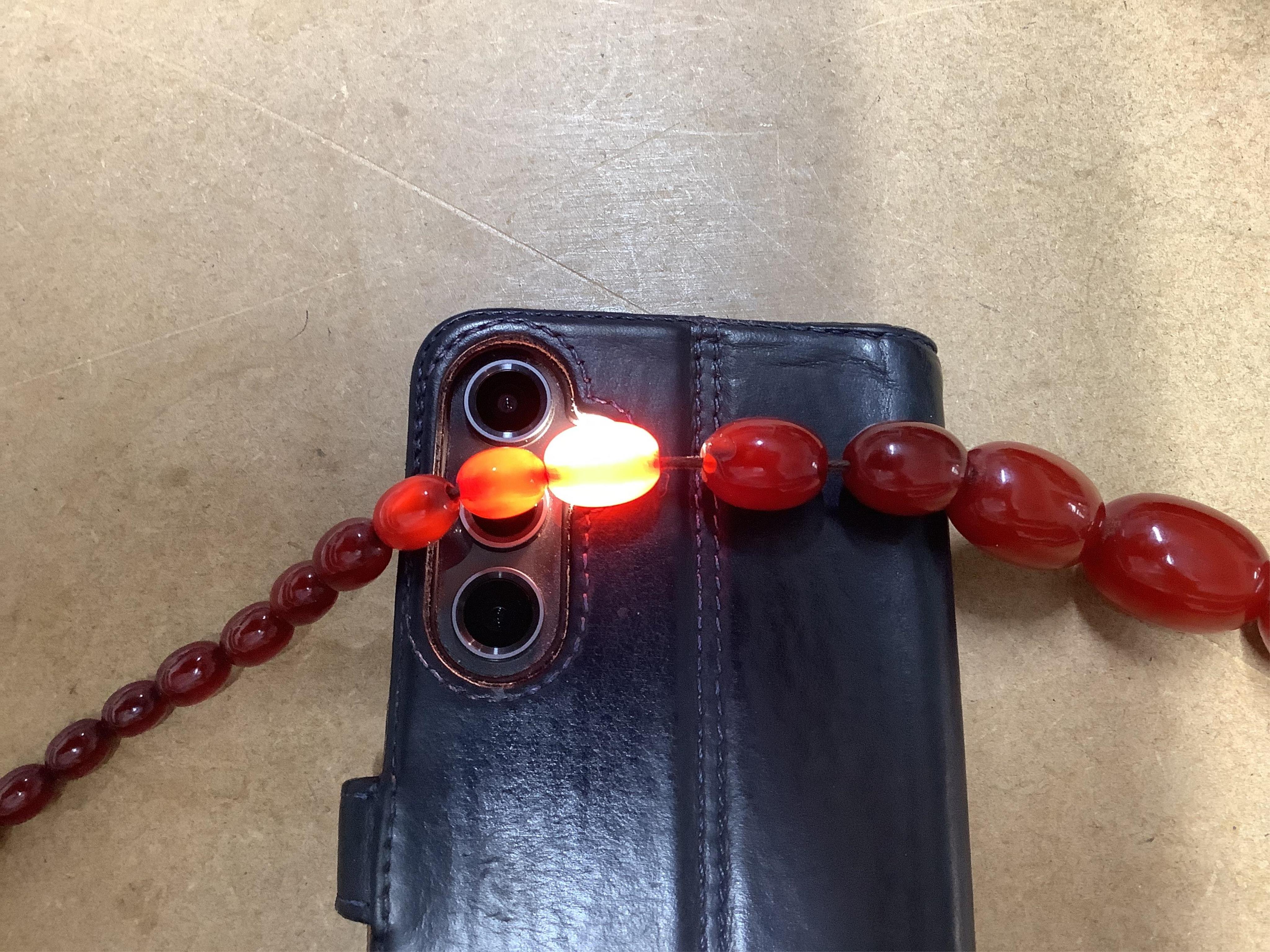 A single strand graduated simulated cherry amber bead necklace, 76cm, gross weight 75 grams.
